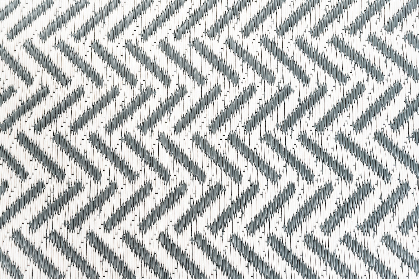 herringbone cool grey outdoor rug woven polypropylene texture close up