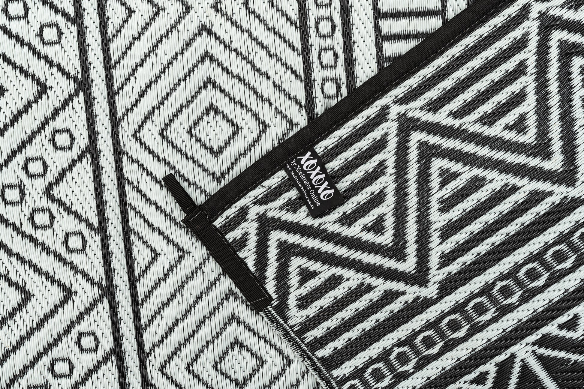 Swazi black outdoor rug folded compact for travel camping mat